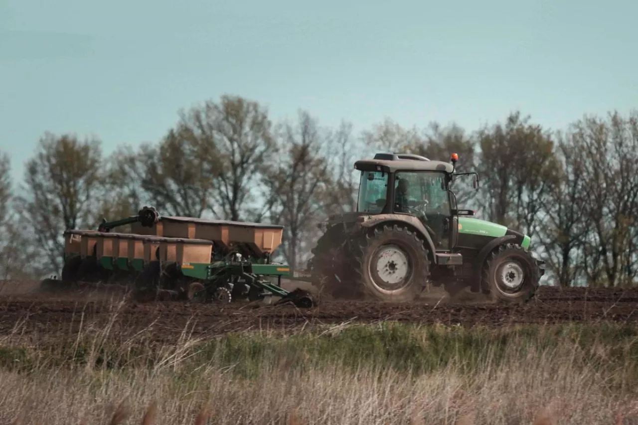 stary ciągnik rolniczy ciągnie przyczepę
